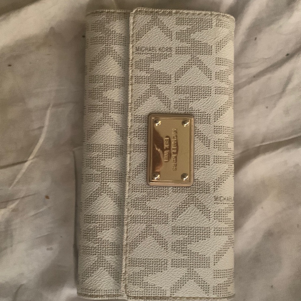 Mk lightly used- good condition besides her one flaw I pictured